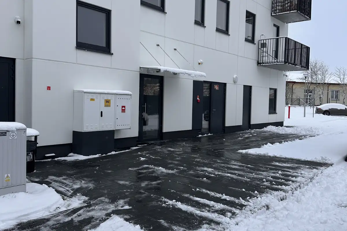Odśnieżony chodnik i wejście do budynku po sprzątaniu terenu zewnętrznego w Lublinie